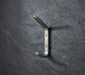 CBH 61 rounded minimalist coat hook installed on textured dark wall modern wall hook design