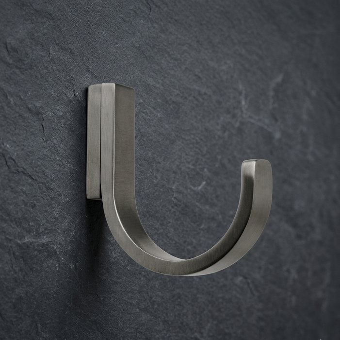 Pewter wall hook CBH 66 installed on dark wall minimalist curved coat hook