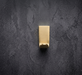 CBH 68 angled projection coat hook in satin brass finish front view on dark wall