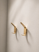 CBH 69 satin brass coat hooks installed on wall in warm interior setting