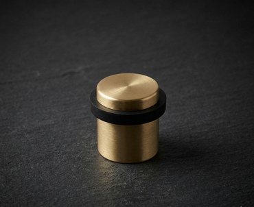 CBH 87 cylindrical floor door stop in antique brass finish with black rubber ring