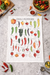 Chili peppers kitchen towel styled with fresh vegetables on kitchen countertop flat lay