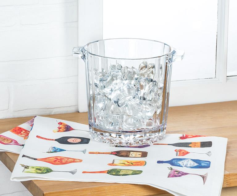 Cocktail kitchen towel with colorful drink illustrations placed under ice bucket on kitchen counter