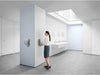 Person using Dyson Airblade V hand dryer in commercial restroom