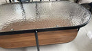 Close-up of the Vista coffee table textured glass top and black metal frame