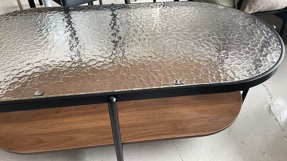 Close-up of the Vista coffee table textured glass top and black metal frame