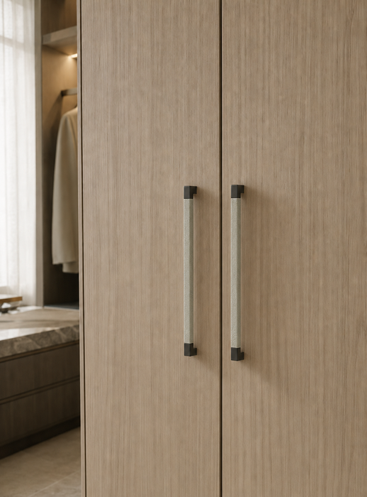 Häfele Elite Leather black cabinet handle installed on a contemporary wardrobe door.