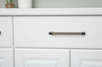 Häfele Elite Leather cabinet handle in black finish installed on a modern cabinet drawer.
