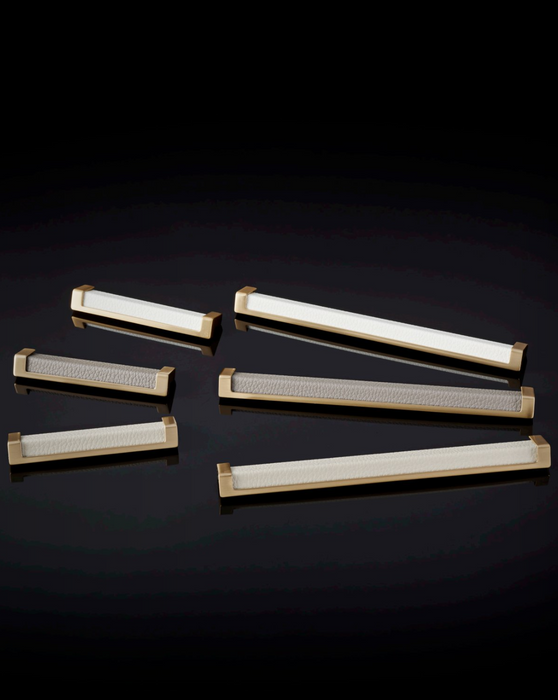 Häfele Elite Leather recessed cabinet handle collection in matte gold featuring Winter, Oyster, and Pewter faux leather inserts.