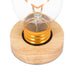 Heart LED lightbulb placed in wooden base close-up view