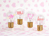 Hearts and arrow neon LED light bulbs displayed on pink decorative background for gifting