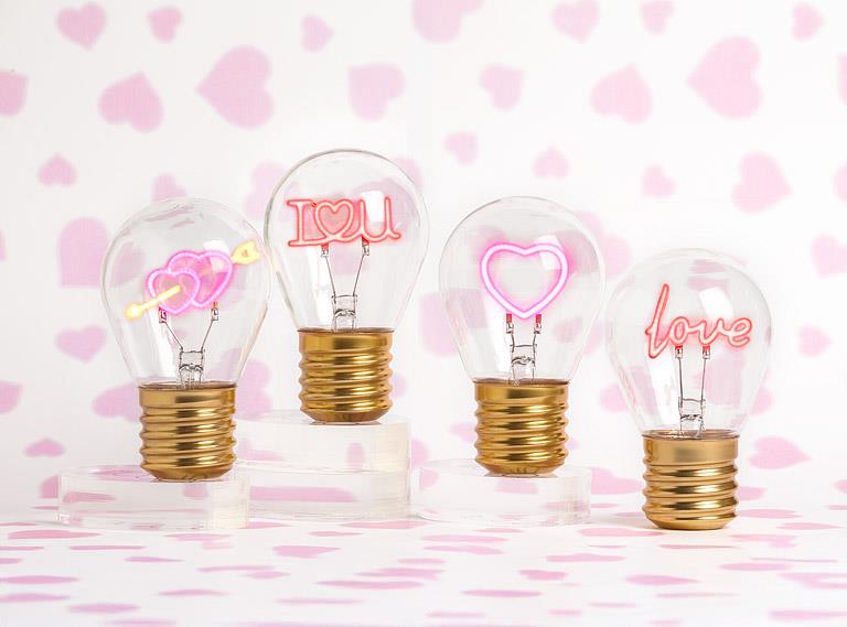I love you neon LED light bulbs arranged on decorative pink background for gift display
