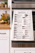 Knife illustration kitchen towel hanging on oven in modern kitchen setting