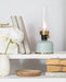 Decorative grey lantern LED lamp displayed on a shelf with books and home decor