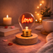 Love neon LED light bulb on wooden base glowing in cozy room setting with warm lighting