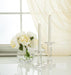 Luxlite Sand LED taper candles displayed in glass holders on a dining table