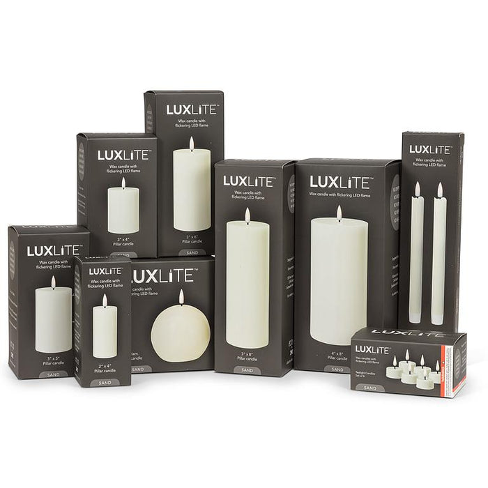 Luxlite flameless LED candles displayed with black retail packaging