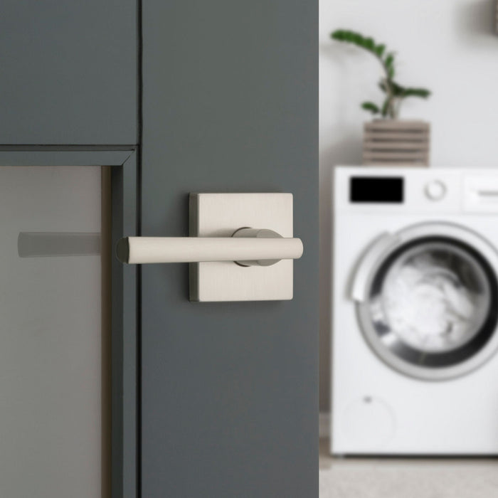 Modern laundry room door featuring a Weiser Montreal Satin Nickel lever handle.