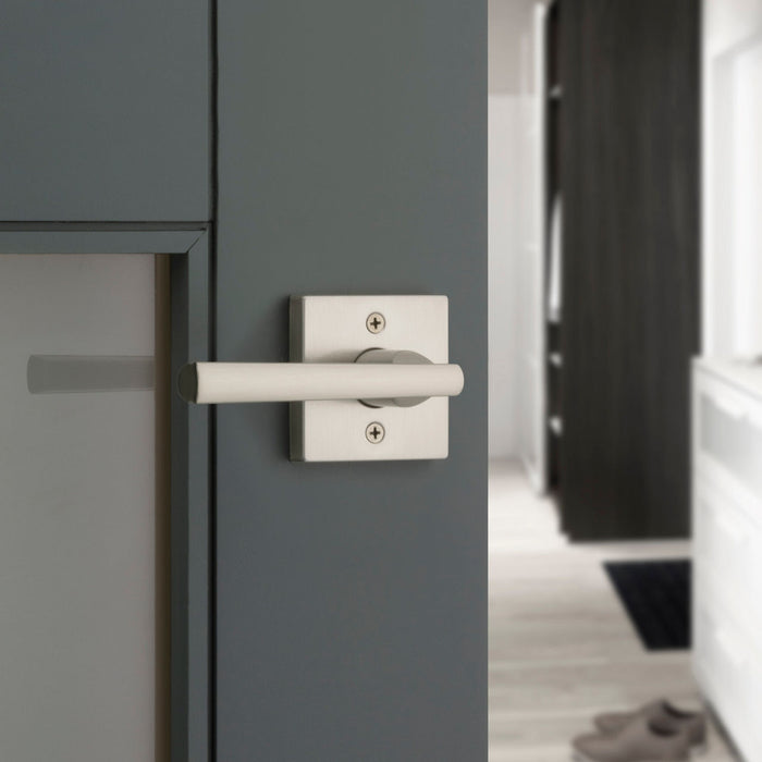 Weiser Montreal square privacy door lever installed on modern bedroom door