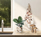 Mushroom print kitchen towel hanging near window with plant and natural light