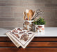 Mushroom kitchen towel displayed on kitchen counter with utensils and rustic decor