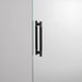 Smoked Bronze Buster + Punch Double-Sided Pull Bar Cross installed on glass door