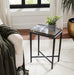 Renwil Aria accent table styled beside a sofa in a modern living room