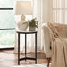 Renwil Arryn marble accent table styled beside a chair in a modern living room