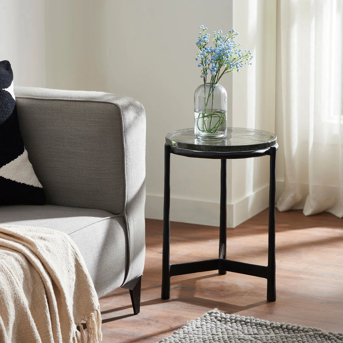 Renwil Avila black glass accent table styled beside a modern lounge chair