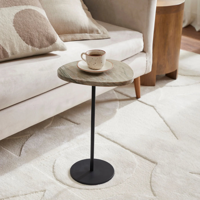 Renwil Bethany marble accent table styled beside a beige sofa in a modern living room