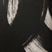 Close-up of black canvas texture and white brushstrokes on Carife wall art