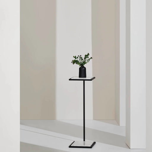 Renwil Danica marble side table styled beside a chair in a modern interior