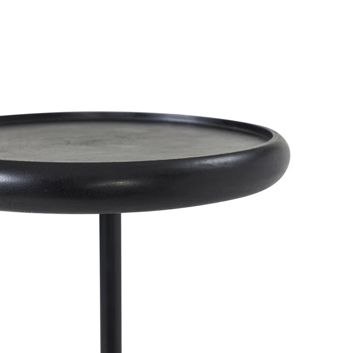 Close-up angled view of black round tabletop on Renwil Hull accent table
