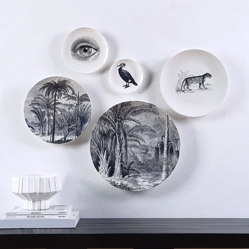 Renwil Maliya decorative porcelain wall plates displayed above a modern console table