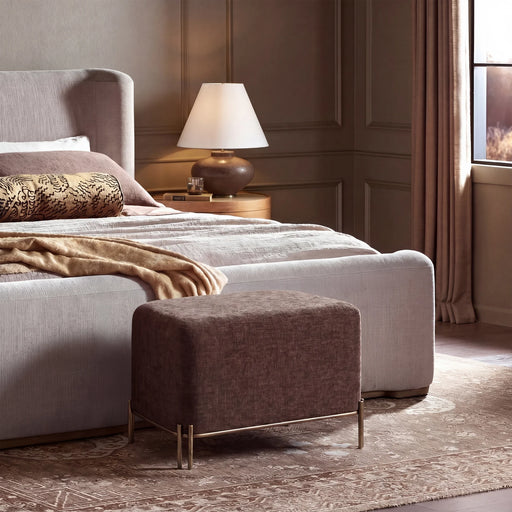 Renwil Meline brown linen ottoman stool styled at the foot of a bed