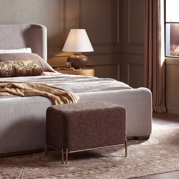 Renwil Meline brown linen ottoman stool styled at the foot of a bed