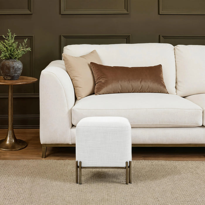 Renwil Meline ivory accent stool styled in front of a living room sofa