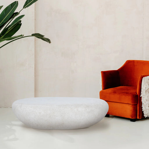 Renwil Minda natural white stone bench styled as a coffee table in a modern living room