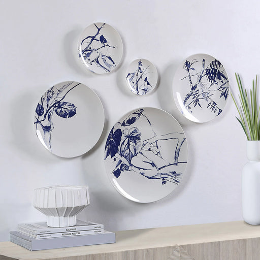 Renwil Narine blue and white porcelain wall plates displayed above a modern console table