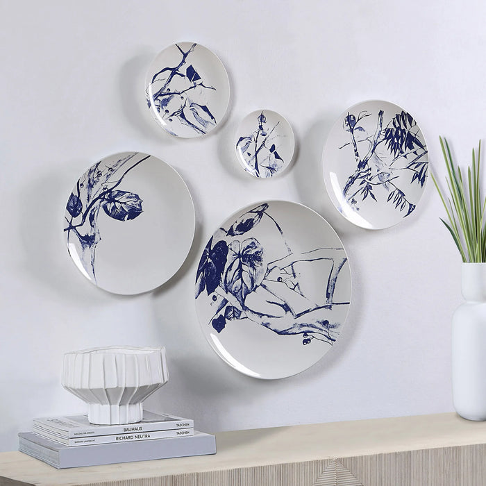Renwil Narine blue and white porcelain wall plates displayed above a modern console table