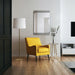 Renwil Pawn brass accent table styled in a modern luxury living room beside a yellow lounge chair