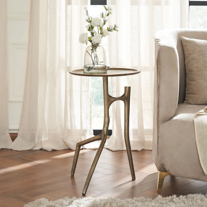 Renwil Tosca brass side table styled beside a sofa in a modern living room