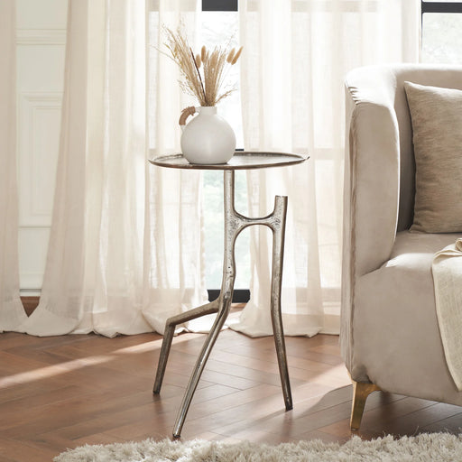 Renwil Tosco nickel side table styled beside a sofa in a modern living room