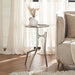 Renwil Tosco nickel side table styled beside a sofa in a modern living room