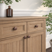 Richelieu 2056 cabinet knob set of 2 installed on wood cabinetry in distressed antique copper finish