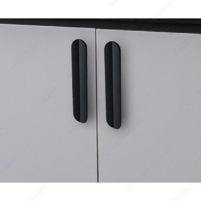 Richelieu 2585 sculpted cabinet pull installed on modern cabinet doors