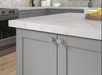 Richelieu 3060 aluminum cabinet knobs installed on grey kitchen cabinetry