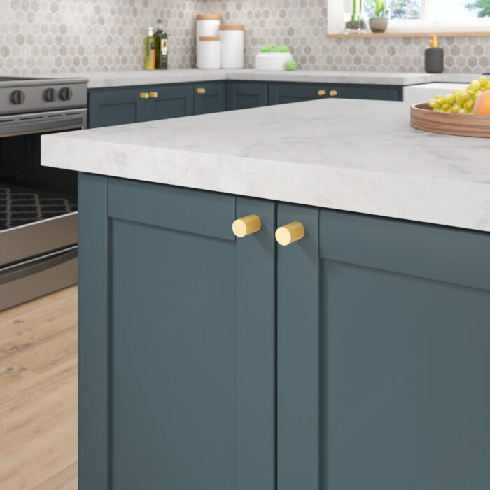 Richelieu 3060 satin brass cabinet knobs installed on blue kitchen cabinetry