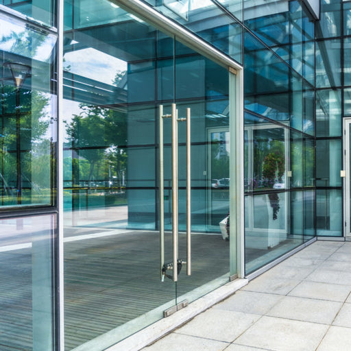 Richelieu stainless steel ladder pull handle installed on a glass door