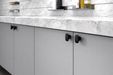 Richelieu 7345 cabinet knob set of 2 installed on modern grey cabinets in brushed nickel finish